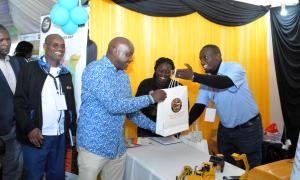 The principal secretary Amos N. Gathecha, ‘ndc’(k). Receiving a gift from the Mechanical and Transport Directorate Stand at the Africa Public Service Week